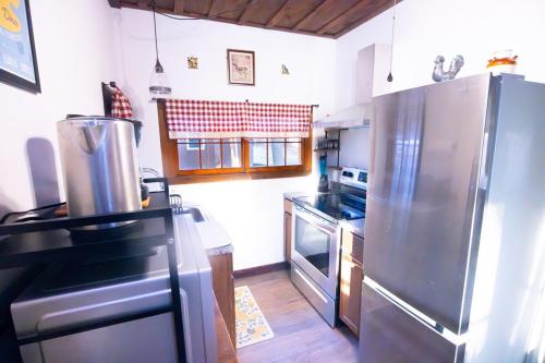 a kitchen with a stainless steel refrigerator and a stove at Rustic Retreat Fireplace, Casino, Camelback Close to everything! in Mount Pocono