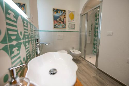 a bathroom with a white toilet and a shower at aMoneglia, 2 minutes walk to the beach, PVT PARK in Moneglia