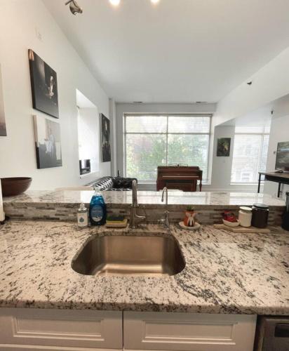 a kitchen with a sink and a counter top at Yale Modern Downtown Chateau in New Haven