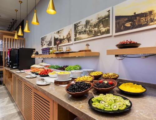 a buffet line with bowls of fruits and vegetables at Park Inn by Radisson Samsun in Samsun