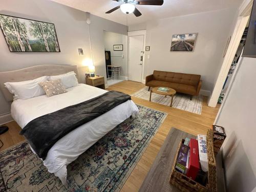 a bedroom with a bed and a living room with a couch at Yale Casa Azul Studio in New Haven