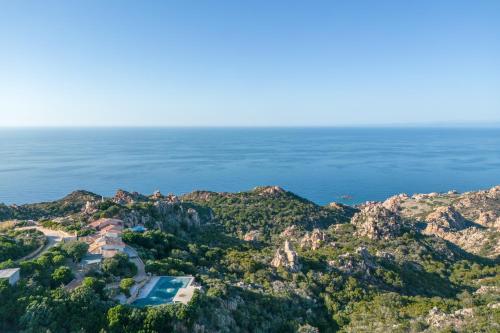 an aerial view of a house on a hill next to the ocean at Villa Alice in Li Valcaggi