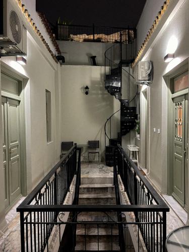 a hallway with a spiral staircase in a building at Acropolis 360 Residence,2 bedr in Athens