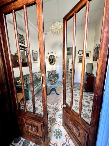 an open door to a living room with a couch at Central Boutique Apartment Near Valletta - Perfect Location to Discover Malta - Bus Stops Just Outside & Adjoining Cafeteria in Msida