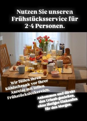 a table full of breakfast food and a flyer at MeerRuhe in Burgtiefe auf Fehmarn 
