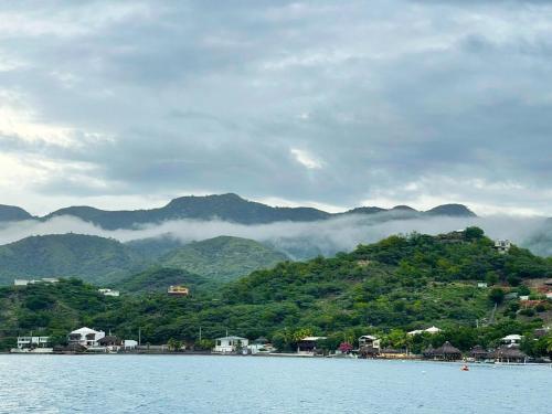 a body of water with mountains in the background at Villa Rosa Bella Perfect for families or groups in Palmar de Ocoa