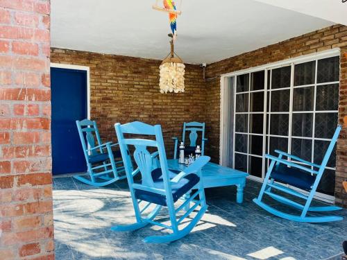 three blue chairs and a table on a patio at Villa Rosa Bella Perfect for families or groups in Palmar de Ocoa