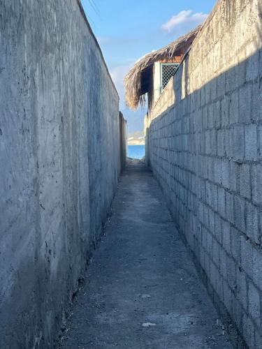 an alley between two walls with the ocean in the background at Villa Rosa Bella Perfect for families or groups in Palmar de Ocoa
