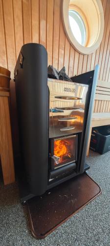 a fireplace in the corner of a room at Hausboot Rollyboot in Joachimsthal