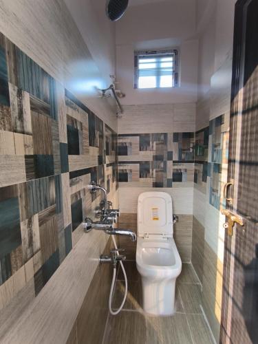 a bathroom with a toilet and a shower at Swagan Home Stays Air Conditioned Deluxe ONE BED ROOM Studio Apartment in Visakhapatnam