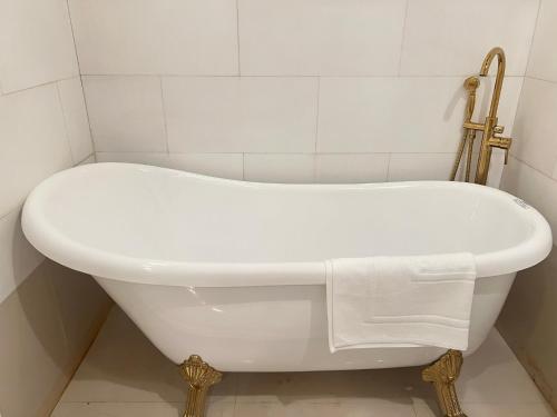 a white bath tub sitting in a bathroom at V20 Boutique Jacuzzi Hotel in Bangkok