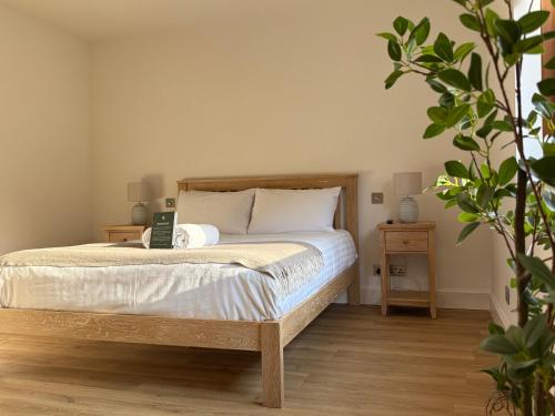 a bedroom with a bed with a laptop on it at Woodlands House with Hot Tub in Ballachulish