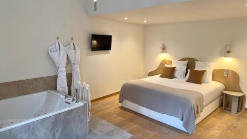 a hotel room with a bed and a bath tub at MiHotel Le Gourguillon in Lyon