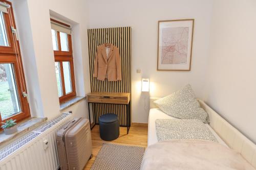 a living room with a suit hanging on a wall at WEINQUARTIER Lindenring 45 qm 2 SZ Altstadt Küche Kaffee in Naumburg