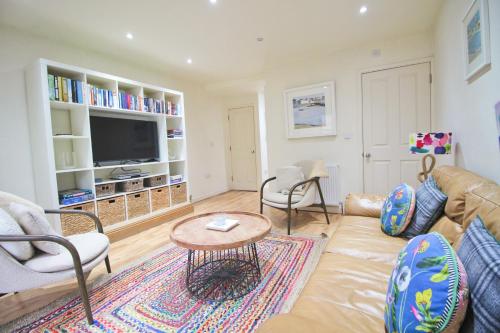 a living room with a couch and a table at Town centre apartment with parking in Padstow