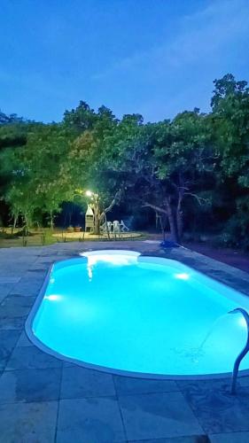 an empty swimming pool in a park at night at Casa Mobiliada próximo do restaurante Bosque da Serra in Santa Fé
