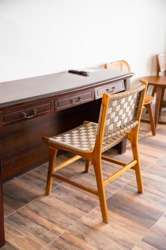 a wooden desk with a chair in front of it at D'girijati Resort And Beachclub in Girijati