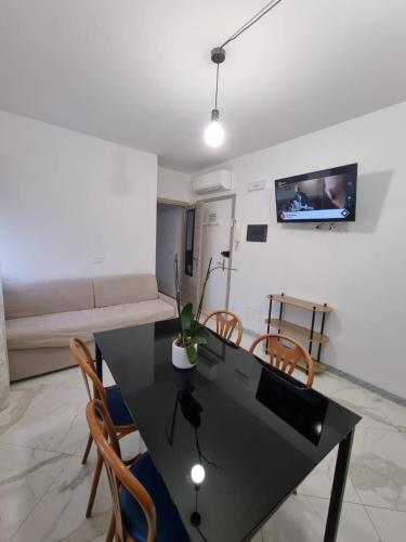 a living room with a black table and chairs at Casa Ale in Ventimiglia