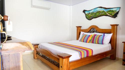 a bedroom with a bed with a wooden frame at Finca Nuevo Monarca in Pereira