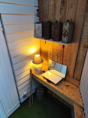 - un bureau avec un ordinateur portable sur une table et une lampe dans l'établissement Appartement Place des Eaux Bonnes, à Eaux-Bonnes