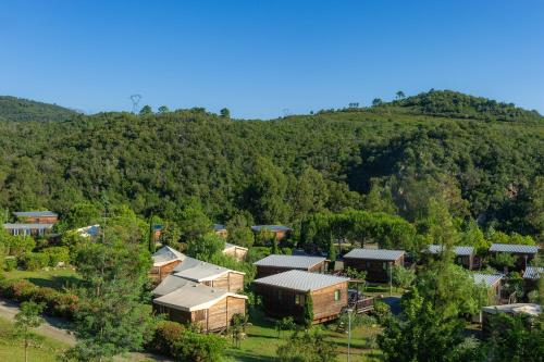 an aerial view of a village in a mountain at Camping Sole Di Sari in Sari Solenzara