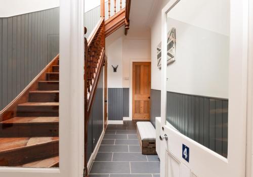 a hallway of a house with a staircase at Harvieston in Elie