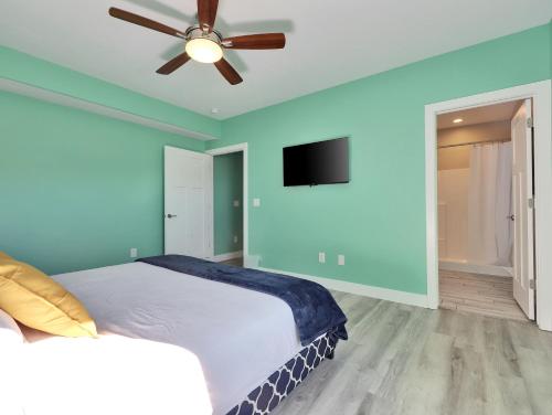 a bedroom with a bed and a ceiling fan at Timeless Hive in Parowan