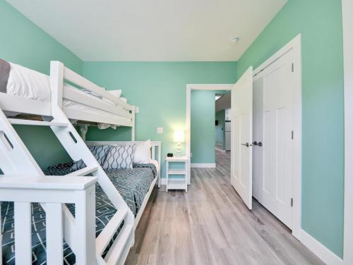 a bedroom with two bunk beds and a hallway at Timeless Hive in Parowan
