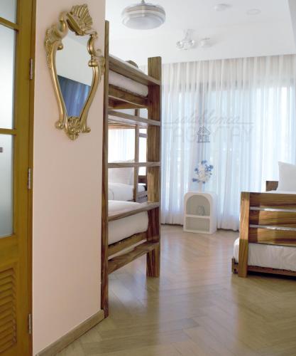a bedroom with bunk beds and a mirror on the wall at Salablanca Brand New Jacuzzi Heated Pool PS5 VR Cinema Fully AC Indoors Smart TVs with Netflix Disney Plus Large Balcony in Tagaytay