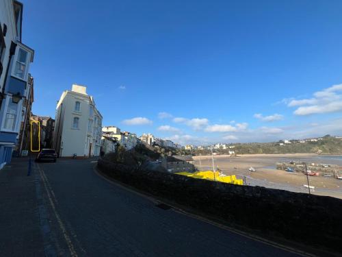 a city street with a building and a beach at Wheelhouse - 3 bedroom home in the heart of Tenby in Tenby