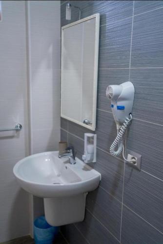 a bathroom with a sink and a mirror on the wall at B&B Benvenuti al Sud in Crotone