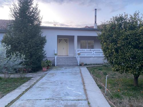 a white house with a white door and stairs at Luxury House in Shkodër