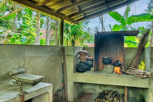 an outdoor stove with pots and a fire at Home stay with nuwan in Bentota