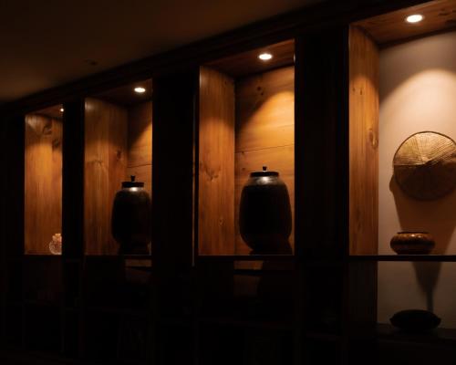a couple of vases sitting on shelves in a room at Willing Resort, Trongsa in Kagha