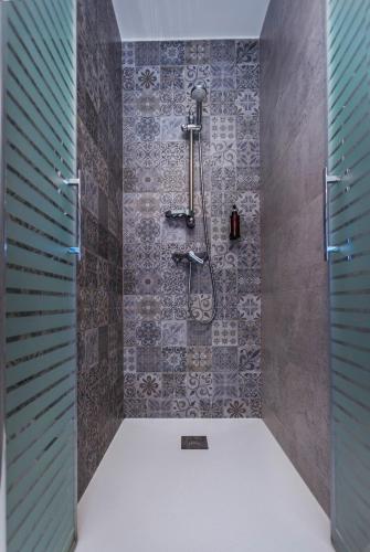 a bathroom with a shower with a tile wall at TOURIÑÁN MAR in Muxia