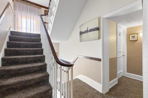 a winding staircase in a home with white walls at The Lansdowne in Leamington Spa