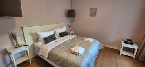 a bedroom with a bed with towels on it at Schlosshotel Hohenbocka in Hohenbocka