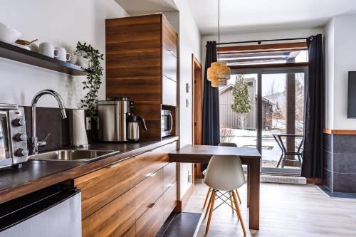 a kitchen with a wooden counter and a table at Lakefront Studio with Resort Mountain View in Lac-Superieur