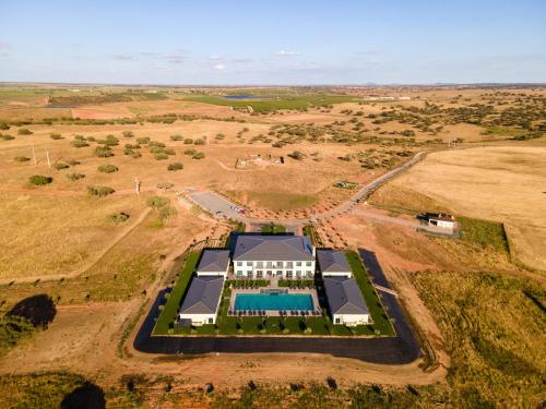 an aerial view of a building with a tennis court at Vila Gale Collection Monte do Vilar in Albernoa