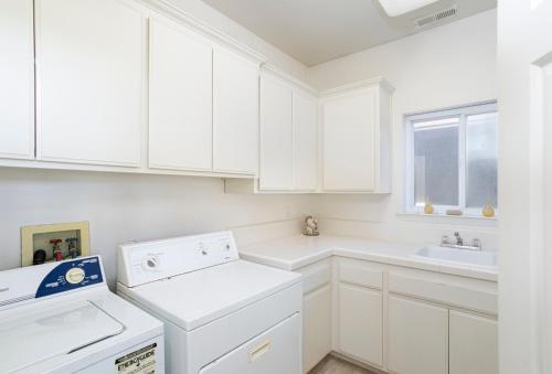 a white kitchen with a dishwasher and a sink at 1730 Laguna Drive in Oceano