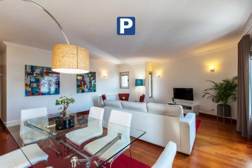 a living room with a couch and a glass table at Oriente 25 Apartments by APT IIN - Parque das Nações in Lisbon