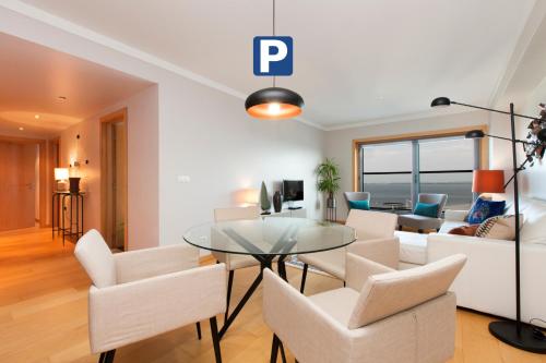 a living room with a glass table and chairs at Oriente 57 Apartments by APT IIN - Parque das Nações in Lisbon