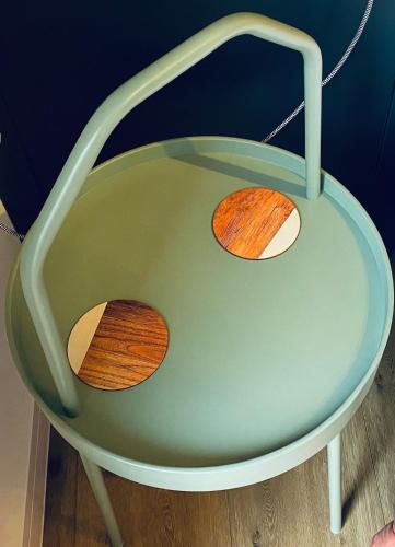 a green chair with two wood slices on it at Brand new en-suite double room private entry self-check in Oxford
