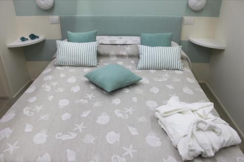 a bedroom with a large bed with towels on it at Clara's House in Portofino