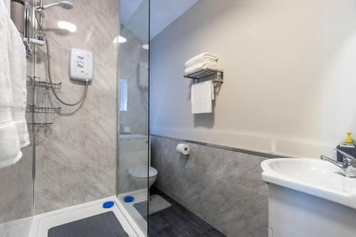a bathroom with a shower and a sink at Diamond Studio Luxury Flat for 3 - Super Fast WiFi in Birmingham