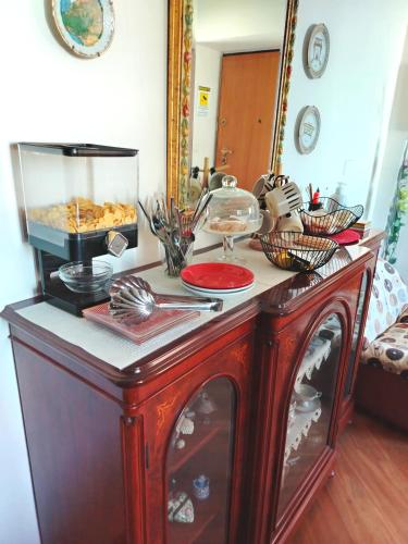 a red cabinet with food on top of it at B&B Corallo in Sassari