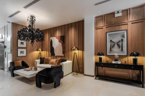 a living room with a couch and a table at The Zénith, By Harrys in Hanoi