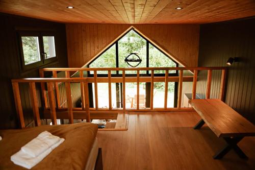 a room with a large window and a couch and a table at Black & White Cekcyn Bory Tucholskie in Cekcyn
