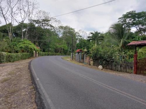 an empty road with a fence on the side of the road at Cabaña Tiquisia in San Lorenzo