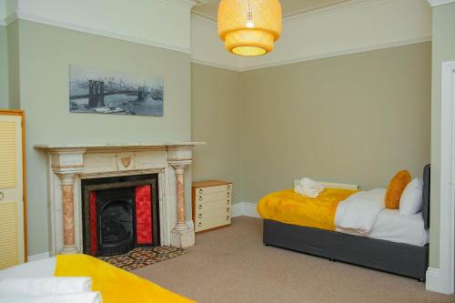 a bedroom with a bed and a fireplace at Elms West Court in Sunderland